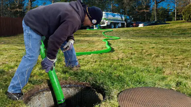 Service technician performing residential septic pumping and drainage maintenance in Atlanta, GA
